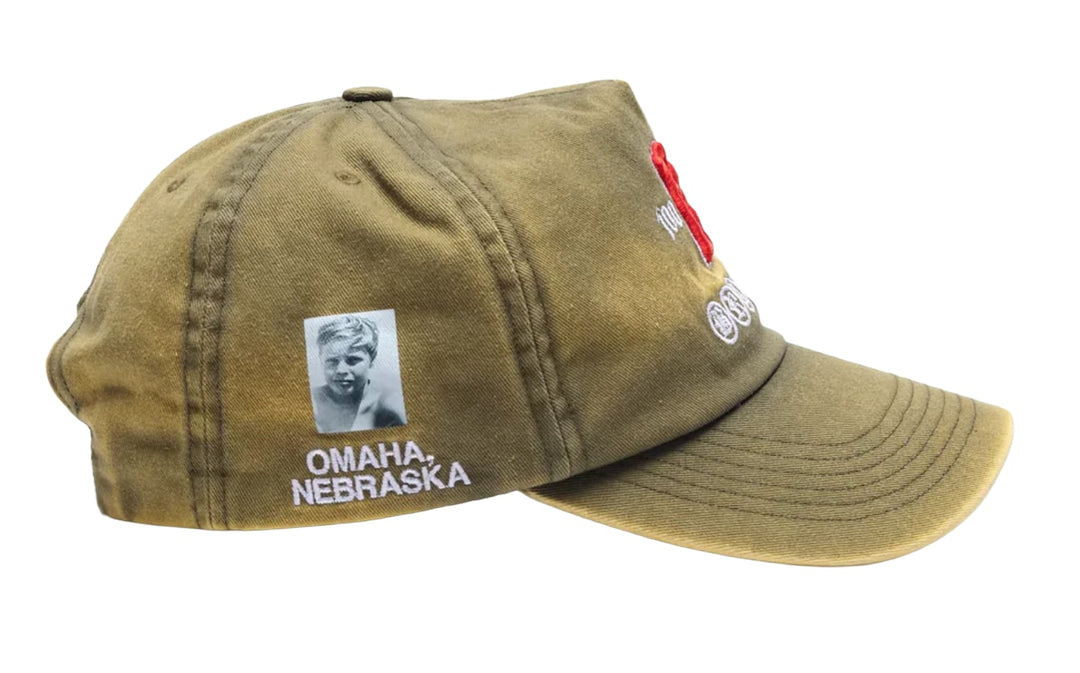 A right-side profile view of the Paly olive khaki hat, showcasing a rectangular vintage-style graphic canvas patch stitched onto the lower side panel featuring a multi-colored illustrative portrait.