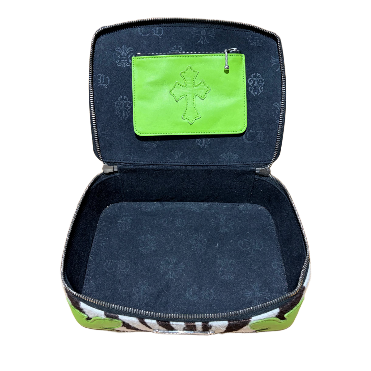 An elevated looking-down view of the fully opened Chrome Hearts jewelry case, showcasing a deep, luxurious navy blue soft suede interior lining divided into custom storage compartments, a dedicated ring roll section, a flat elasticated pocket under the lid, and a pop of neon green leather framing the interior perimeter walls.