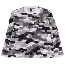 Front flat lay view of the Matty Boy Anti Promo crewneck thermal longsleeve shirt in a grayscale camouflage waffle-knit pattern, featuring a small green and pink cartoon character graphic printed on the left chest below the crew neckline.