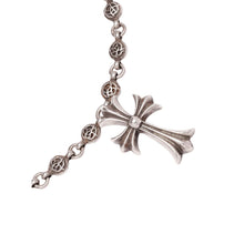 Close-up view of the lower section of the necklace, highlighting the connection where the spherical chain links meet the polished sterling silver gothic cross pendant.