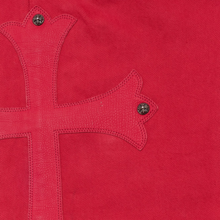 A close-up view focusing on the front right hip panel, highlighting the heavy twill weave texture of the red dyed denim canvas, precise tonal stitching along the traditional curved side slip pocket, and clean seam joins framing the upper waistband area.
