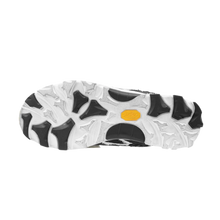 A full view of the underside of the shoe, showcasing the heavy-duty high-traction rubber outsole layout featuring an aggressive, organic multi-directional lug design executed in a striking marbled white-and-black camo pattern, split by a solid black structural midfoot shank plate for technical trail stability.