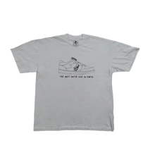 Front flat lay view of the Warren Lotas short-sleeve t-shirt in white cotton, featuring a central illustrated graphic print of a customized skeleton-themed sneaker with text below reading 'THE MOST HATED SHOE IN AMERICA'.