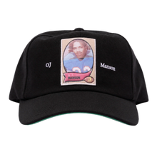 A straight front studio layout view of the Paly 'OJ Manson' hat, showcasing an unstructured six-panel vintage dad hat profile crafted from a premium washed jet-black cotton twill canvas, featuring a curved stitched brim, a centralized rectangular photo-graphic panel patch screen-printed on the front crown depicting an athletic sports trading card image, flanked on either side by minimal white printed script reading 'OJ' and 'Manson'.