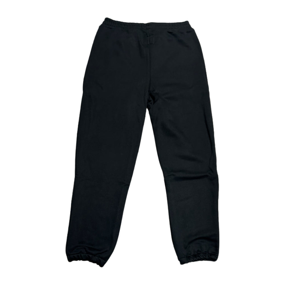 Back flat lay view of the black Saint Vanity varsity fleece sweatpants, showcasing the relaxed structural taper profile stretching from the gathered elastic waistband down to the cuffed ankles, with a solid, unadorned jet-black rear panel design.